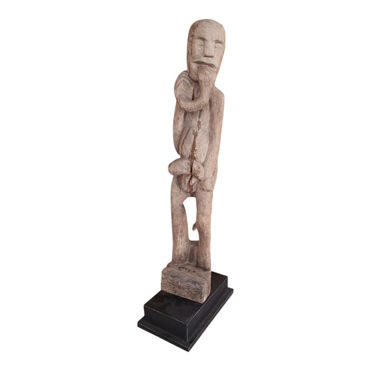 Statue masculine indonésienne en bois avec serpent sculpté, posée sur socle noir – 84 cm